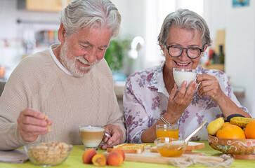 Beautiful senior couple having breakfast at home. Retirement lifestyle