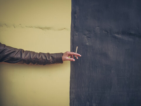 person holding herble cigarette