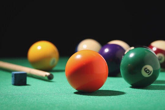 Many colorful billiard balls on green table