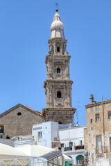 Fototapeta na wymiar The bell tower of the Basilica of the Madonna della Madia, Monopoli Cathedral in the old town of Monopoli, Puglia, Italy