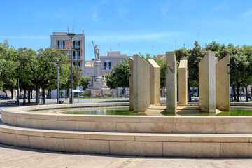 Fototapeta na wymiar Fountain and War Memorial in Vittorio Emanuele square in Monopoli, Puglia, Italy