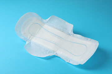 Sanitary napkin on light blue background. Gynecology concept