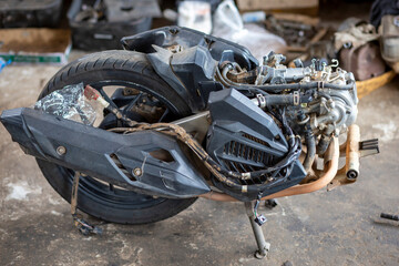 The body, tube, and rear wheel of the motorcycle Auto transmission in a motorcycle repair shop waiting for disassembly to repair Automatic Bike engine parts.