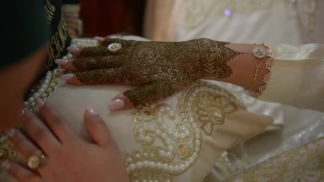 Woman hand being decorated with henna tattoo, mehendi.Arab wedding. Moroccan traditions