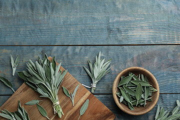 Fresh green sage with board and bowl on light blue wooden table, flat lay. Space for text - obrazy, fototapety, plakaty