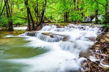 Waterfall and blue emerald water color in Huay Mae Khamin national park. Huay Mae Khamin, Beautiful nature rock waterfall steps in tropical rainforest at Kanchanaburi province, Thailand