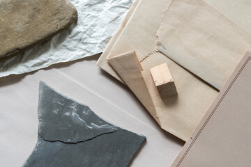 composition with isolated sand stone, slate rock, crumpled, folded, and flat paper, and wooden...
