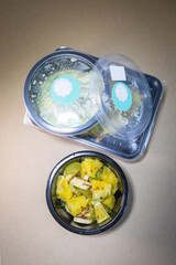 top view fruit salad with pineapple and banana in a container. Food delivery