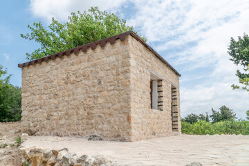 Fototapeta na wymiar a small stone house under blue sky
