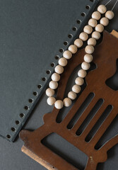 spiral book cover, stringed and untreated wood beads, with decorative wood object on dark grey