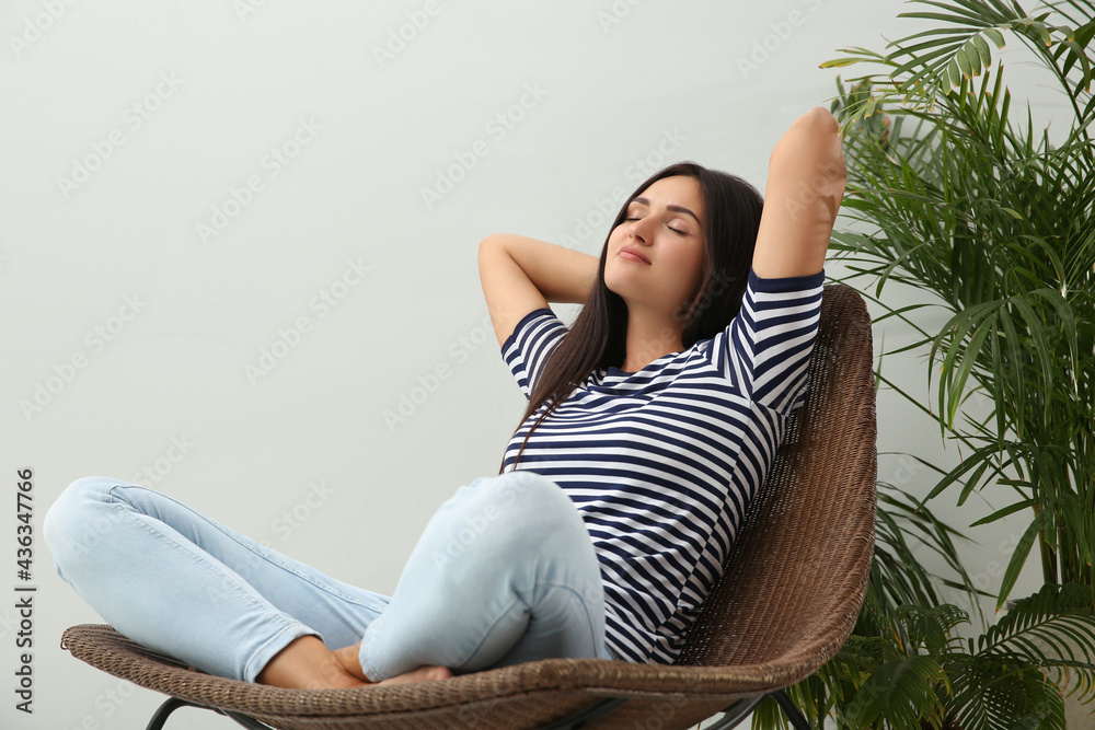 Canvas Prints Young woman relaxing on chair at home