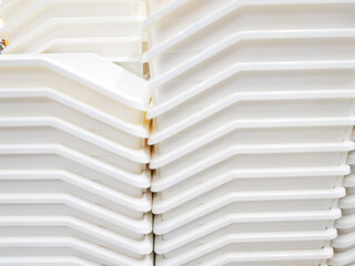 Obraz premium Stack of white plastic container box storage. Plastic containers for home use stack in a store for sale. Houseware store plastic containers.