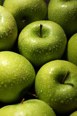 Ripe green apples with water drops as background, closeup