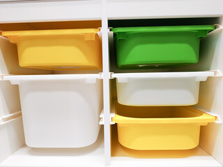 Stack of multi colors plastic container box storage. Plastic containers for home use stack in a store for sale. Houseware store plastic containers.