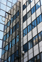 Fototapeta na wymiar Looking up to facade of building reflecting in windows