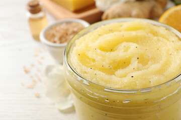 Body scrub in glass jar on white table, closeup. Space for text