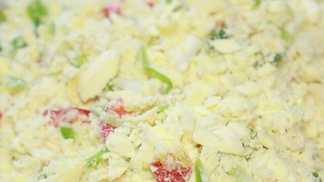 mixing breadfruit with salted cod fish, green bell peppers