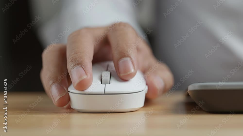 Poster Click white computer mouse on a work desk. Working with a PC or laptop. Footage of the workplace in 4K