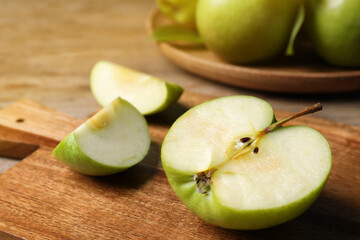 Fototapeta na wymiar Cut fresh green apple on wooden table, closeup
