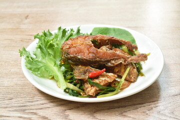 deep fried slice striped snake head fish with ginger and celery on dish