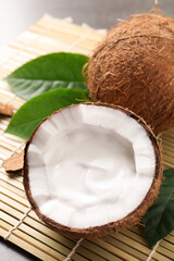 Ripe coconut with cream on bamboo mat