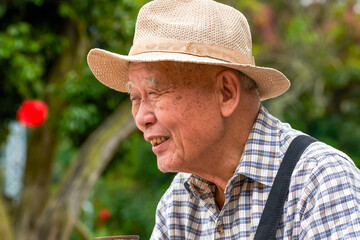 Close-up of an old Asian man resting in the park
