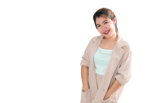 An Asian woman standing with her hand in her pocket and smiling.