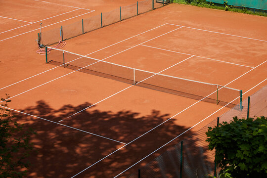 Clay court tennis court.The sun is shining. The weather is good and you feel like hitting a few balls. Birds eye view.