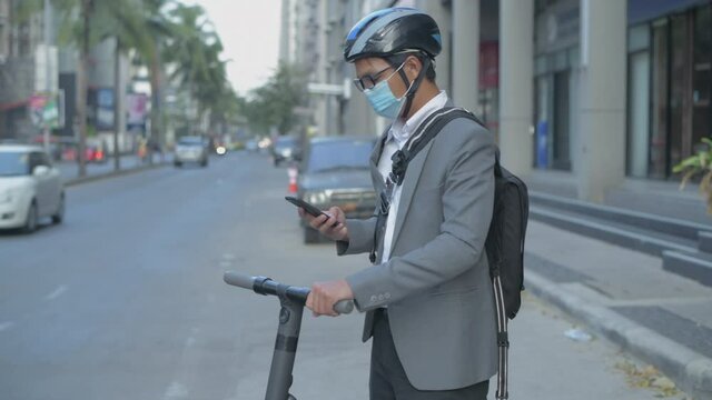 Energy efficient travel vehicle concept of 4k Resolution. Asian men are using mobile phones to explore urban commute.