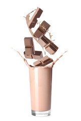 Choco bars falling into glass with delicious chocolate milk on white background