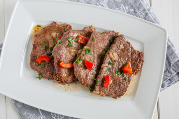 Braised beef cooked with red pepper, served on a plate