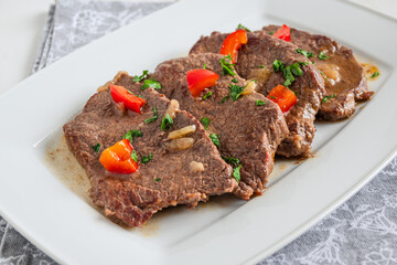 Braised beef cooked with red pepper, served on a plate
