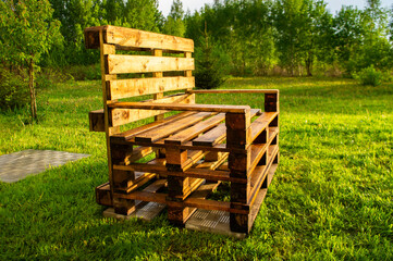 Beautiful hand made garden furniture of pallets on the lawn in summer. Landscape design