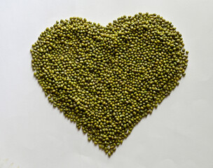 A pile of Fresh Mung Beans in the shape of a heart on the white background, Full depth of field.