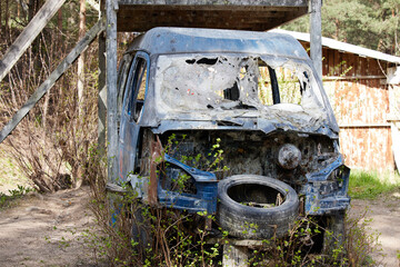 Photo scrap metal, rusty car in the forest