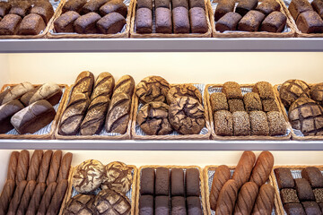 Freshly baked traditional dark bread in a baker shop. Different