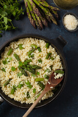 Classic Italian risotto with asparagus. Top view. Darkblue background.