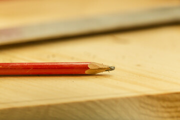 craftsman pencil on a plank to mark a measured line