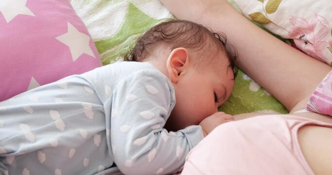 Woman breastfeeding newborn baby. Baby eating mother's milk. Concept of lactation infant