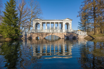 View of the ancient Marble Bridge on a sunny May day. Catherine Park in Tsarskoe Selo. Suburb of...