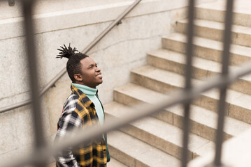 Black man on a stairs in the city.