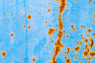 Rusty and crumbling blue steel wall