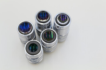 Detail of microscope lens on an white background.Closeup of microscope objectives.