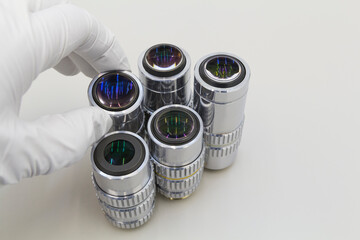 Detail of microscope lens on an white background.Closeup of microscope objectives.
