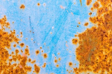 Rusty and crumbling blue steel wall