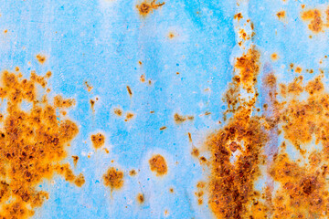 Rusty and crumbling blue steel wall