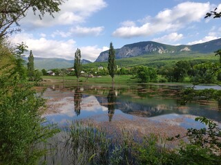Crimean peninsula. Summer landscape in the mountainous Crimea with a lake, trees and clouds.