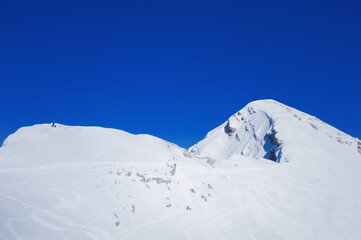 Fototapeta na wymiar little skalpinist climbs a snowy mountainside slovenian alps Mala Mojstrovka