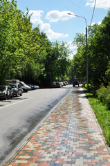 Panorama of the city. The tractor cleans the paths of the city square. Moscow, Russia, May 22, 2021