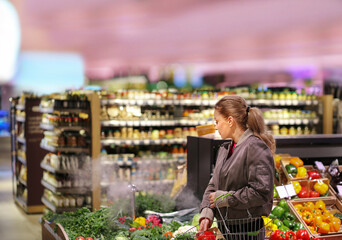 Woman buying fruits and vegetables at the market